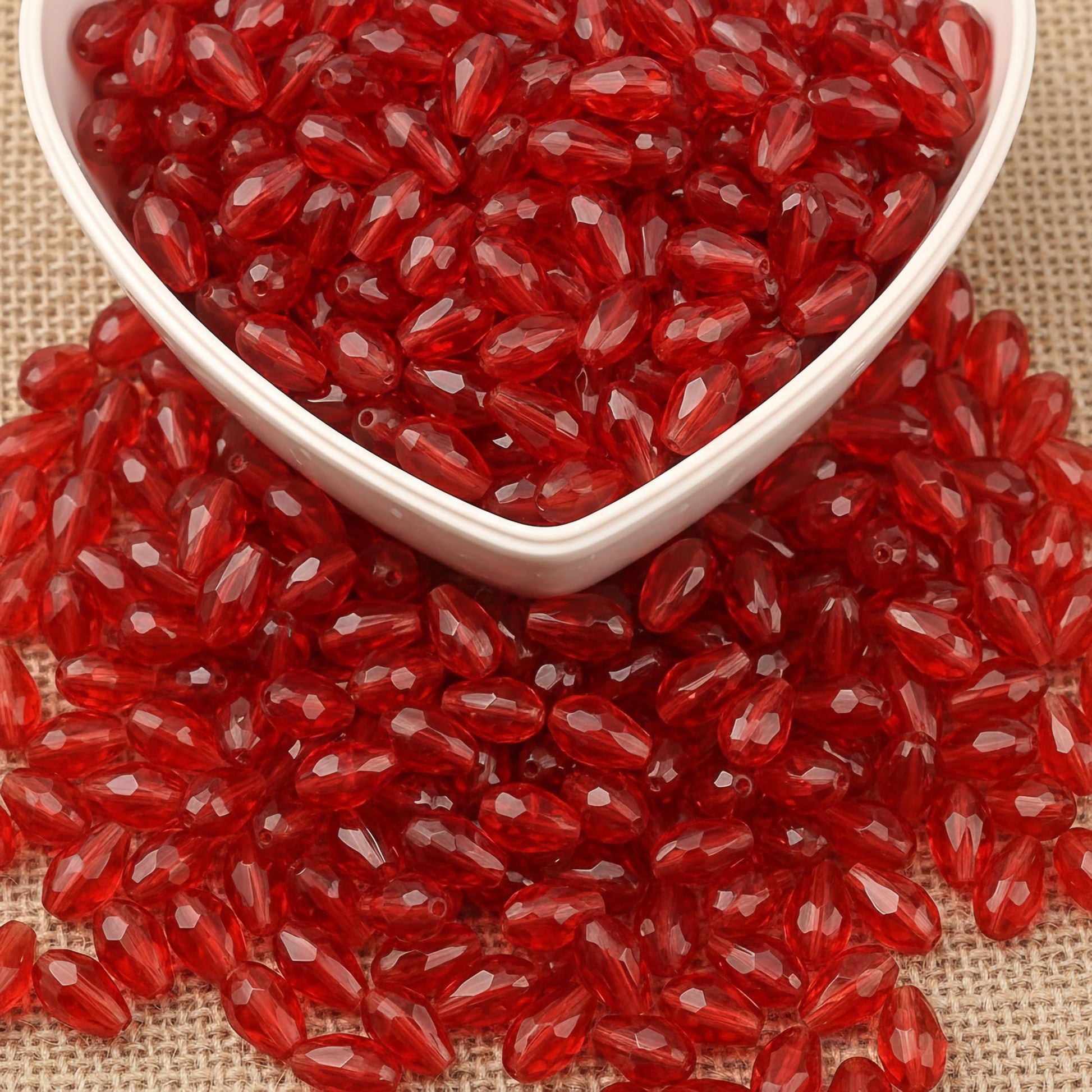 Design delicate charms, anklets and earrings with 15x10mm red cut-facet teardrop beads.