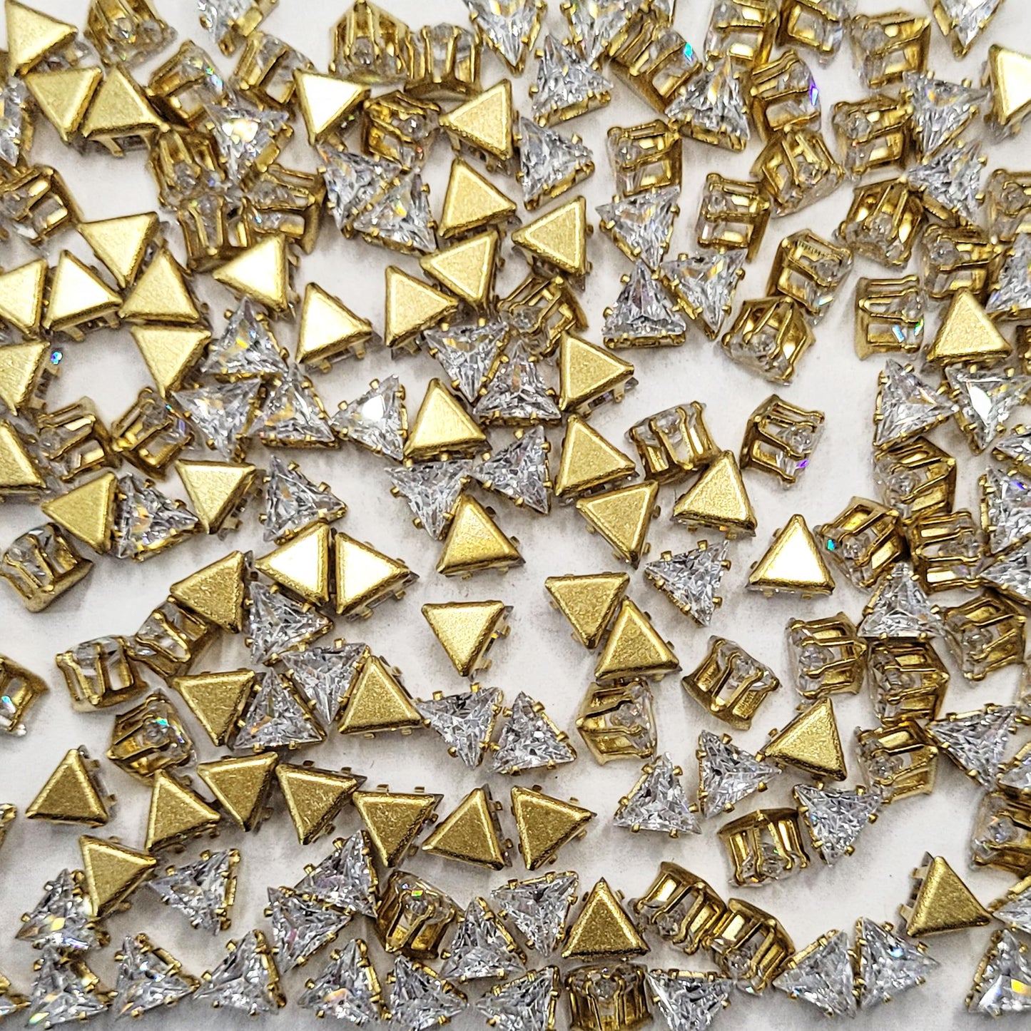 Triangle 5x5x5 and gold rhinestone and stone rhinestones and flatback stones offer a sparkling look for embellishment work, Lippan art and fabric decoration.