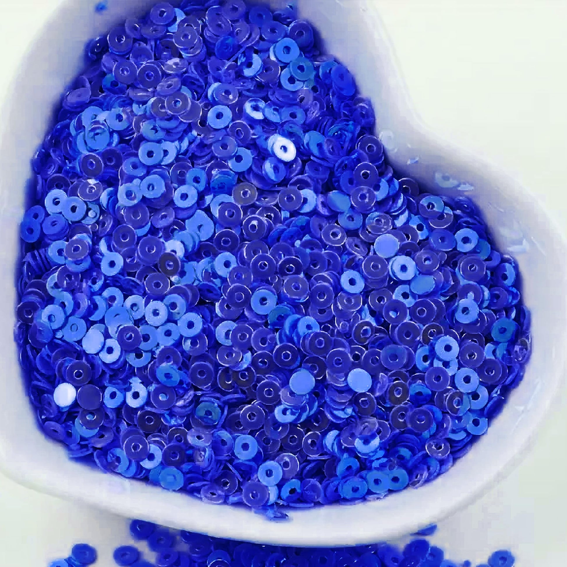 In Embroidery for embroidery, craft decoration and fabric embellishment, blue 4mm sequins round shape 4mm sitara sequins with holes add depth and neat finishing.