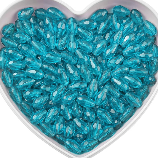 Add graceful dangle accents to earrings and charms with 15x10mm cyan faceted teardrop beads.