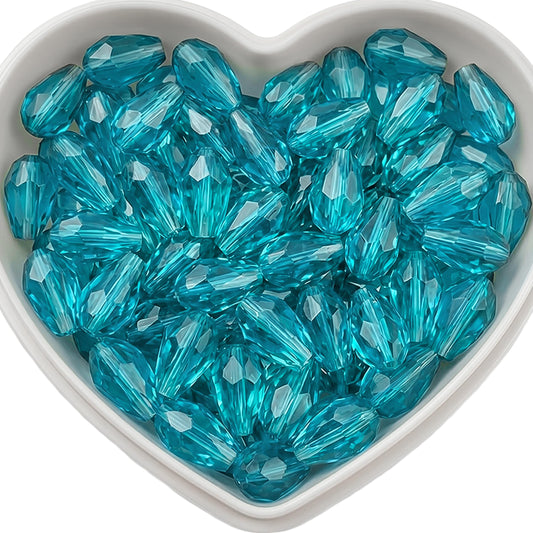 Add graceful dangle accents to earrings and charms with 10x6mm cyan faceted teardrop beads.