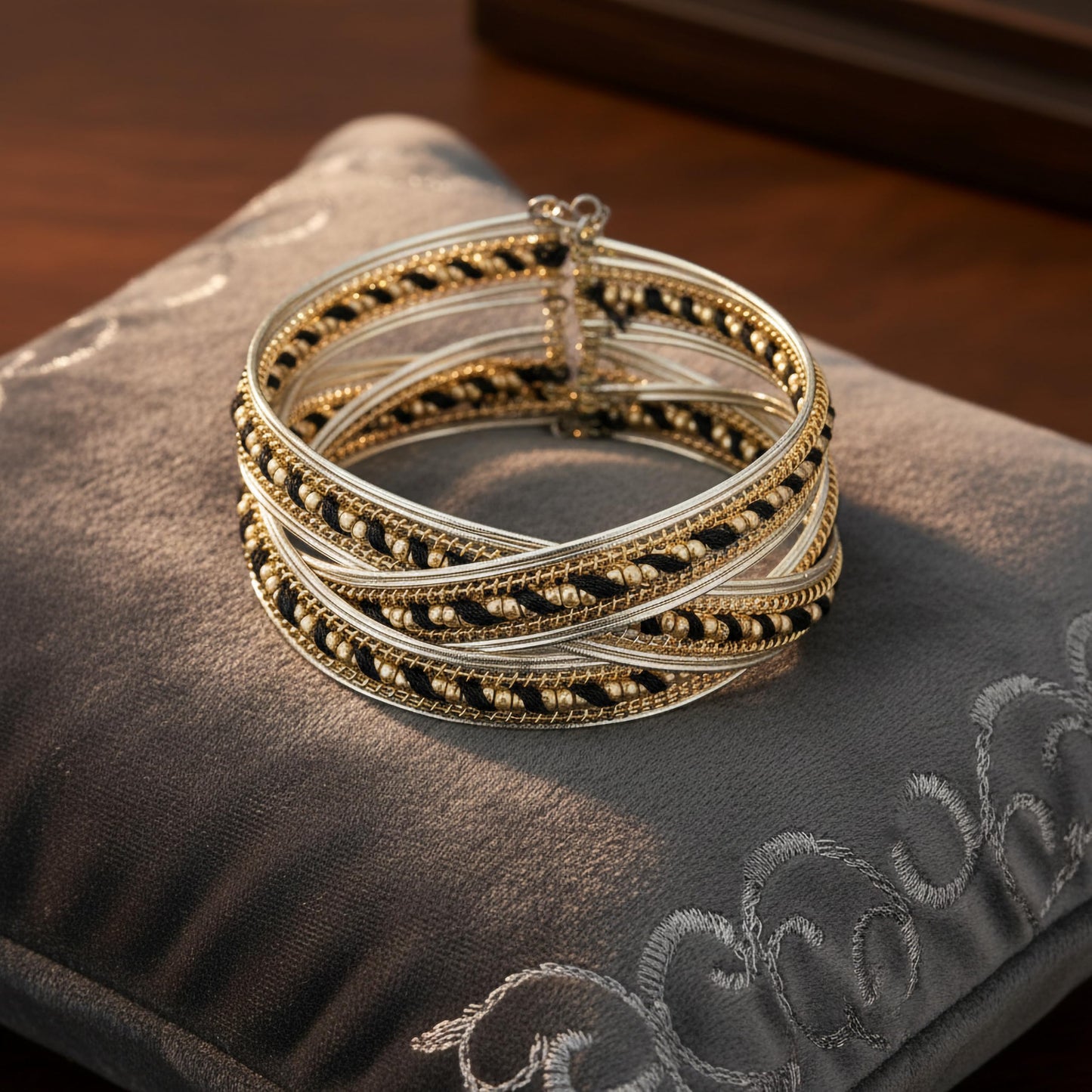 Gold and black wide cuff bracelet with layered bead design.