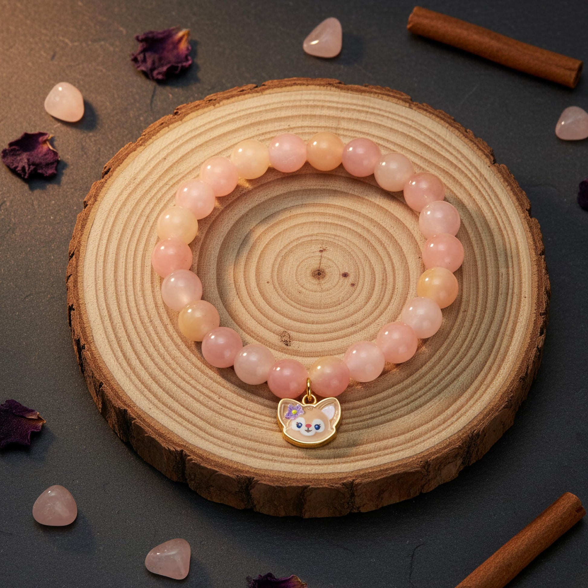 Layer cute wrist stacks with peach dualtone bead details and charm accents.