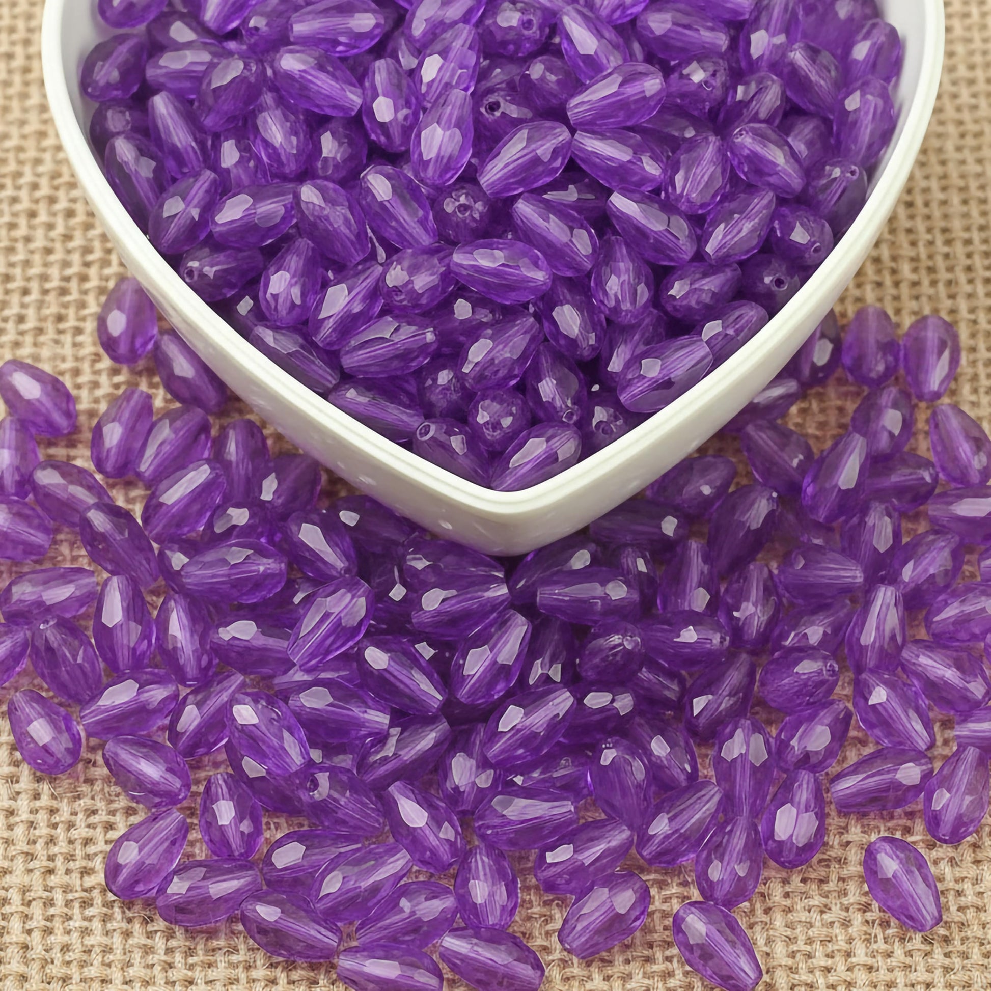 Design delicate charms, anklets and earrings with 15x10mm purple cut-facet teardrop beads.