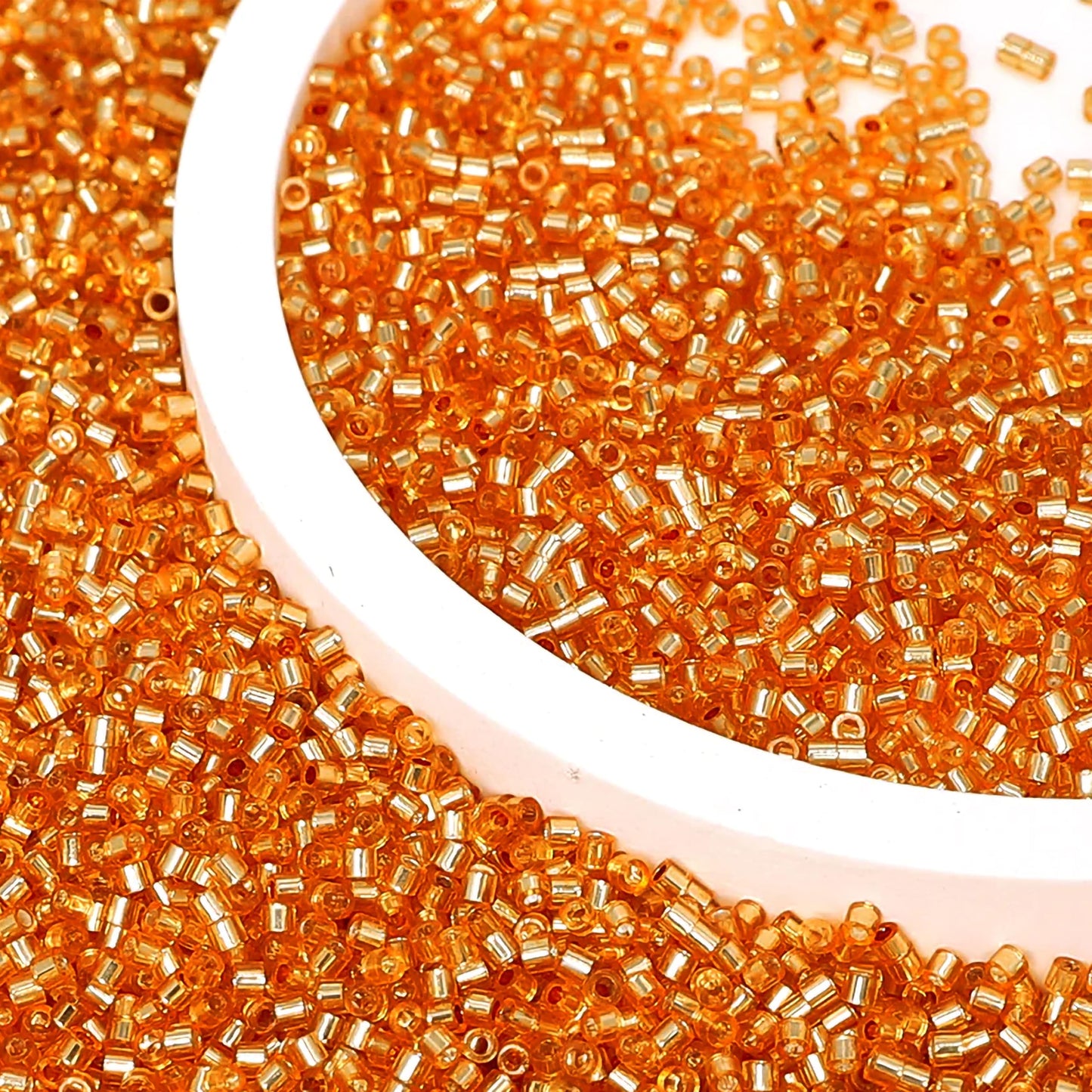 Orange and silver 2.5mm small cut cylinder silverline tubes 2.5mm shiny makes DIY craft projects, creative hobby work and decorative handmade designs look more complete.